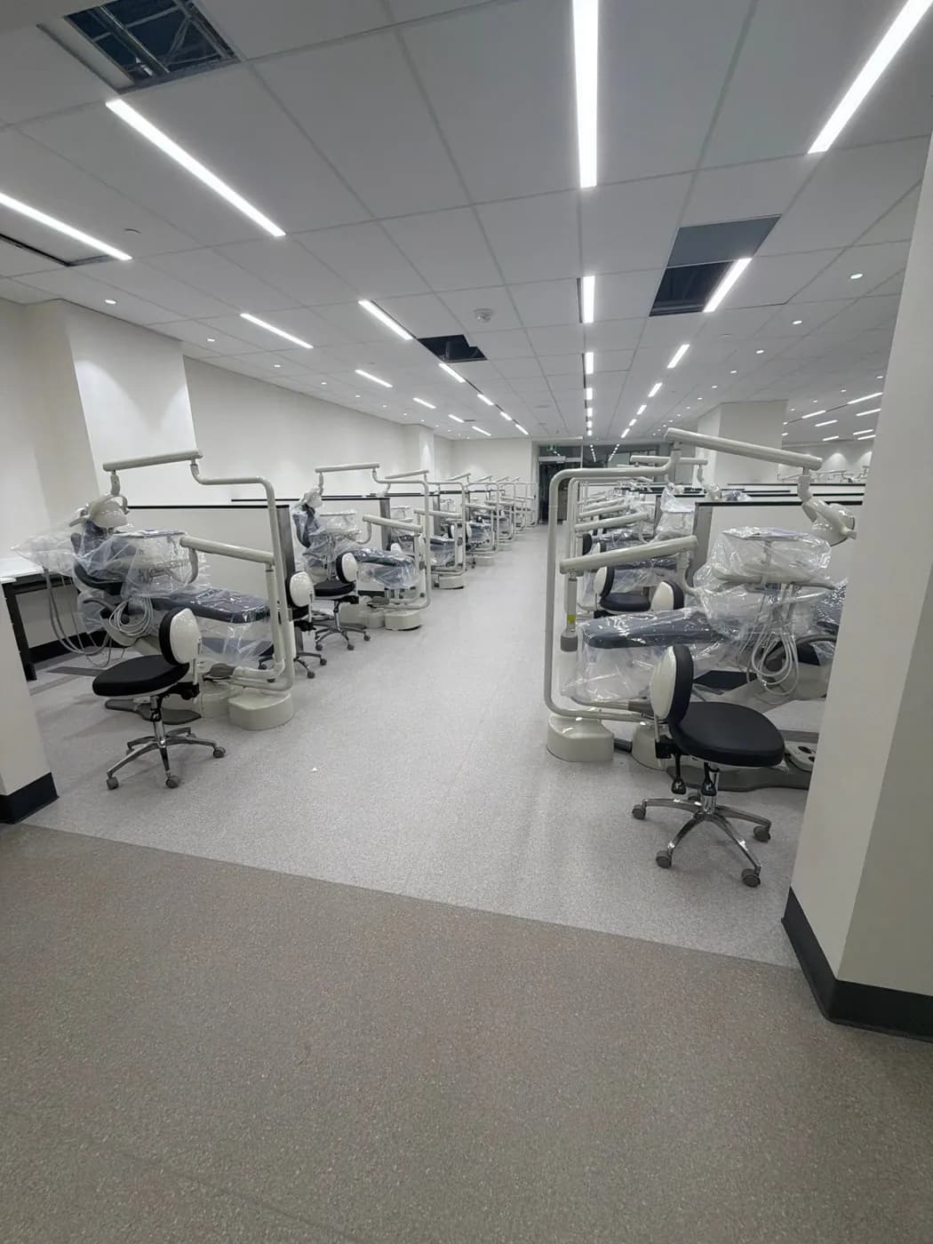 Dental school clinic with rows of dental chairs and spotless floors after a Tidal Cleaning visit