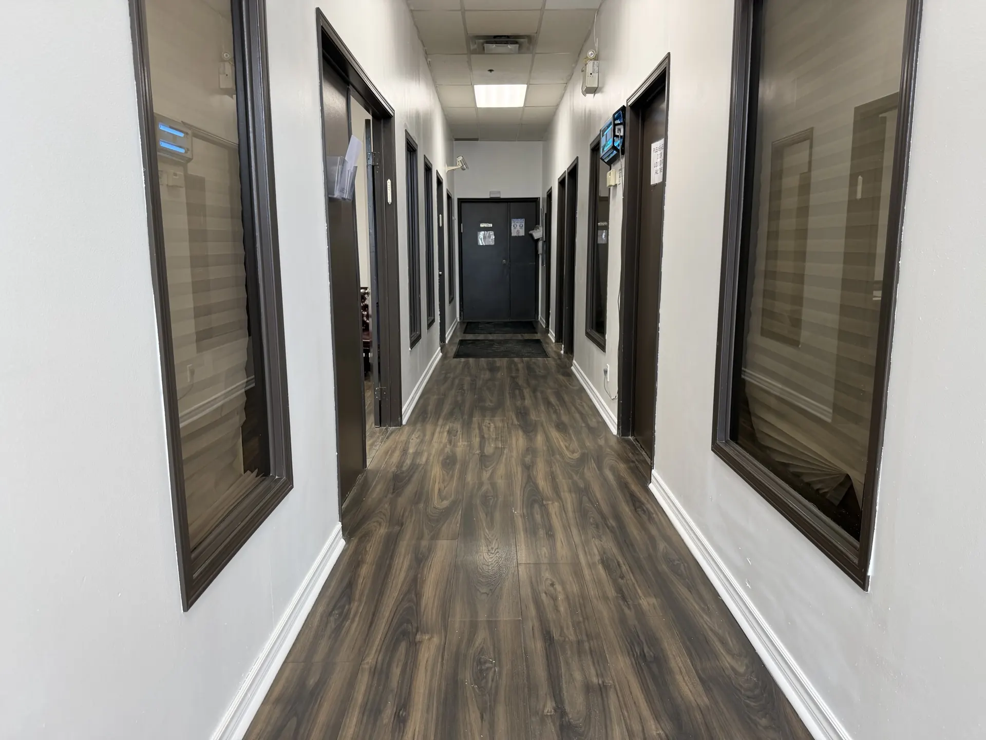 LDF Frozen Foods office hallway with clean wood-look floors and spotless glass after a Tidal Cleaning visit