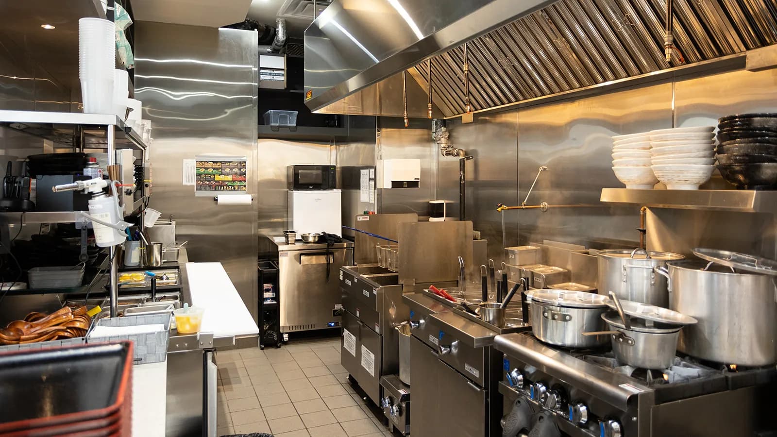 Ramen Isshin commercial kitchen in Mississauga with degreased hood, stainless steel walls and cooking equipment cleaned by Tidal Cleaning